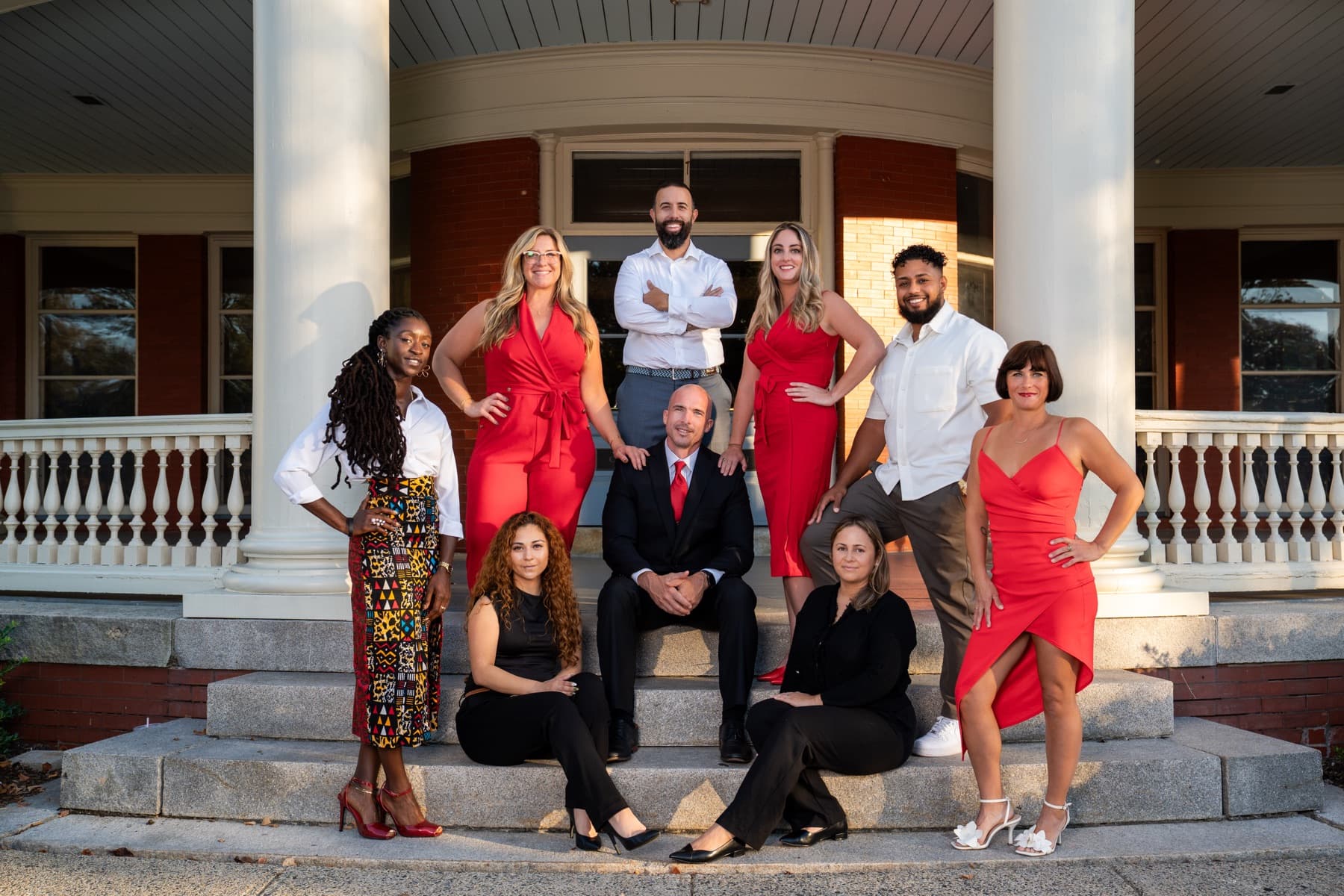The Here Realty team together on the porch steps