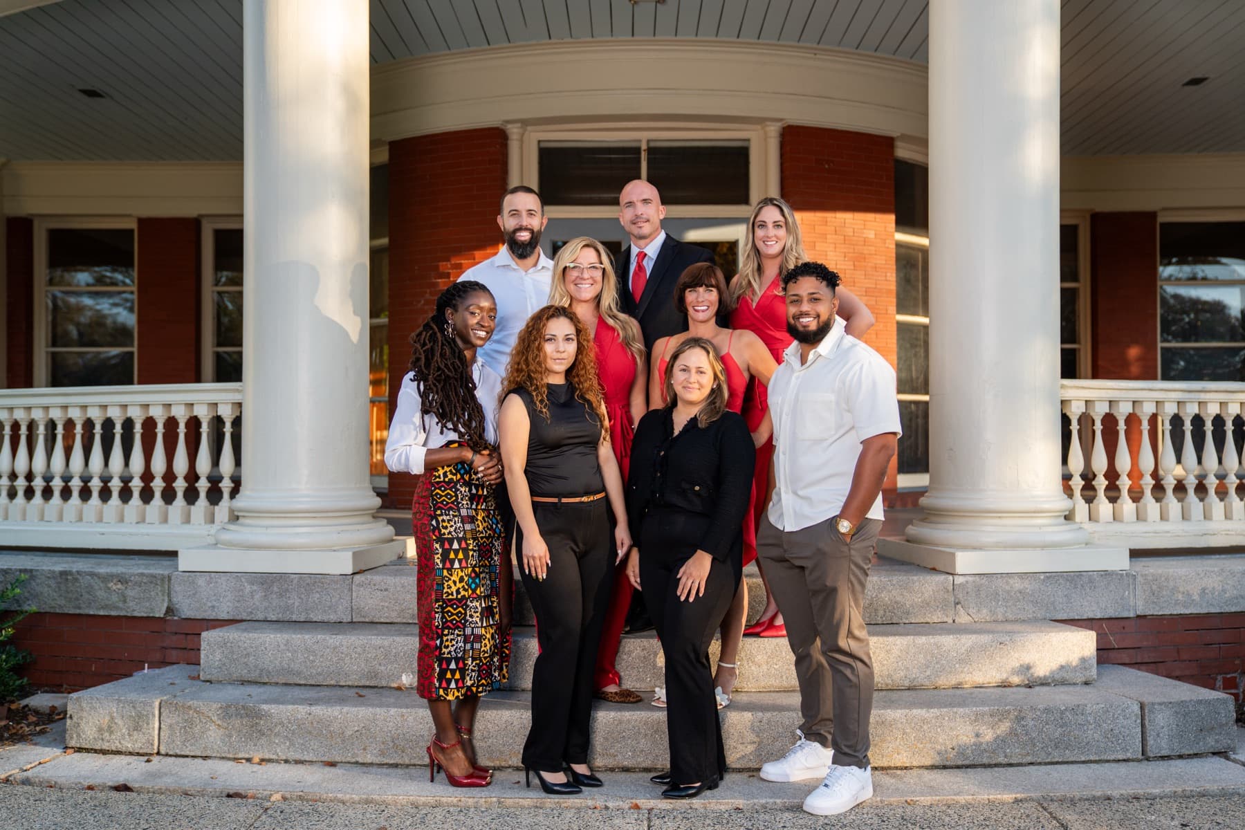 The Here Realty team together on the porch steps