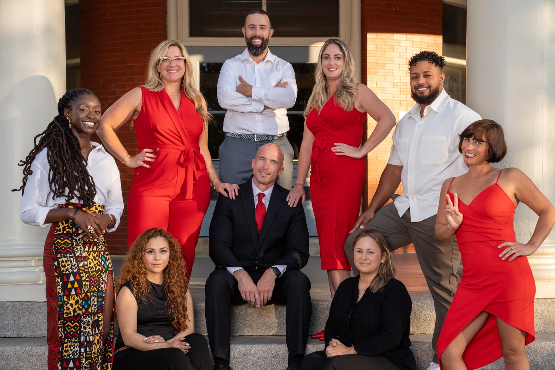 The Here Realty team together on the porch steps
